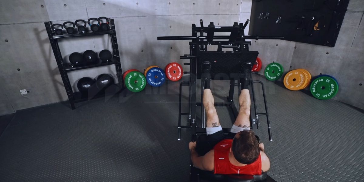 Leg Press Foot Placement Variations: top-down view of athlete on 45-degree leg press, feet on footplate showing neutral stance.