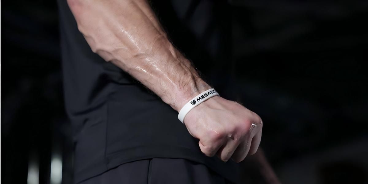 Close-up of a muscular arm wearing a Megastar fitness wristband, symbolizing strength and dedication in an Advanced Muscle-Building Guide: Take Your Gains to the Next Level.