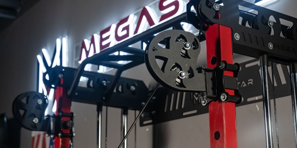 Close-up of the pulley and cable system on a MEGASTAR all-in-one Smith machine power rack, showing the functional trainer components.